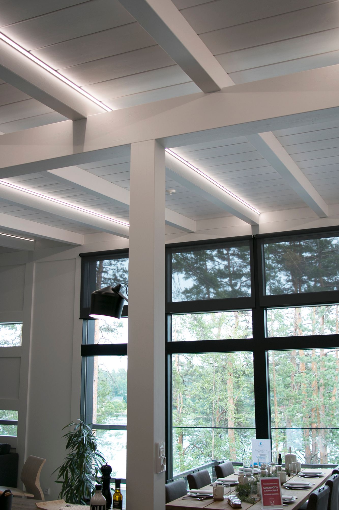 LED strips mounted on corner profiles to highlight the beams. Ledstore.fi